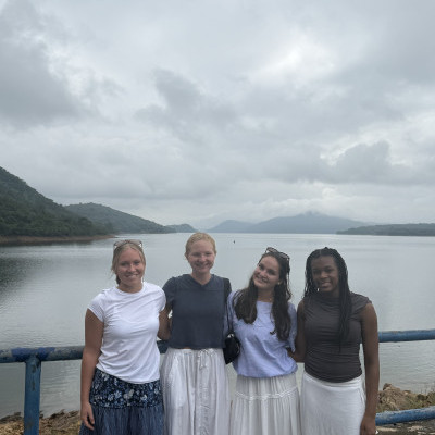Four people with a lake in the background