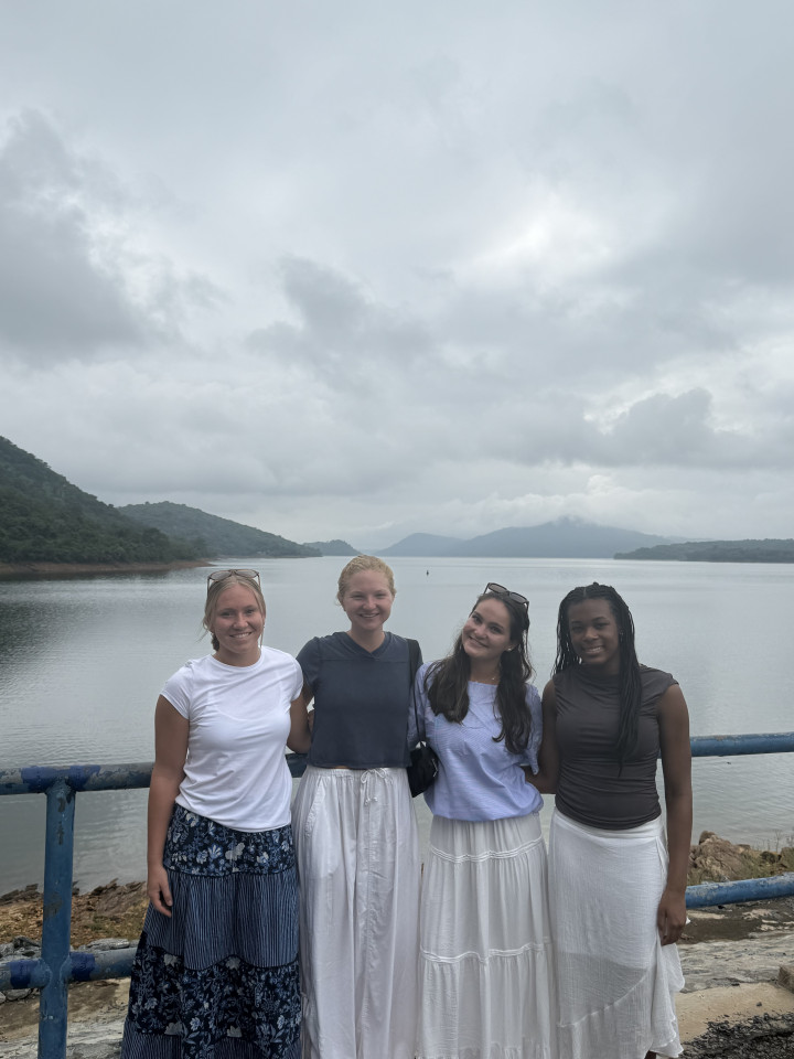Four people with a lake in the background